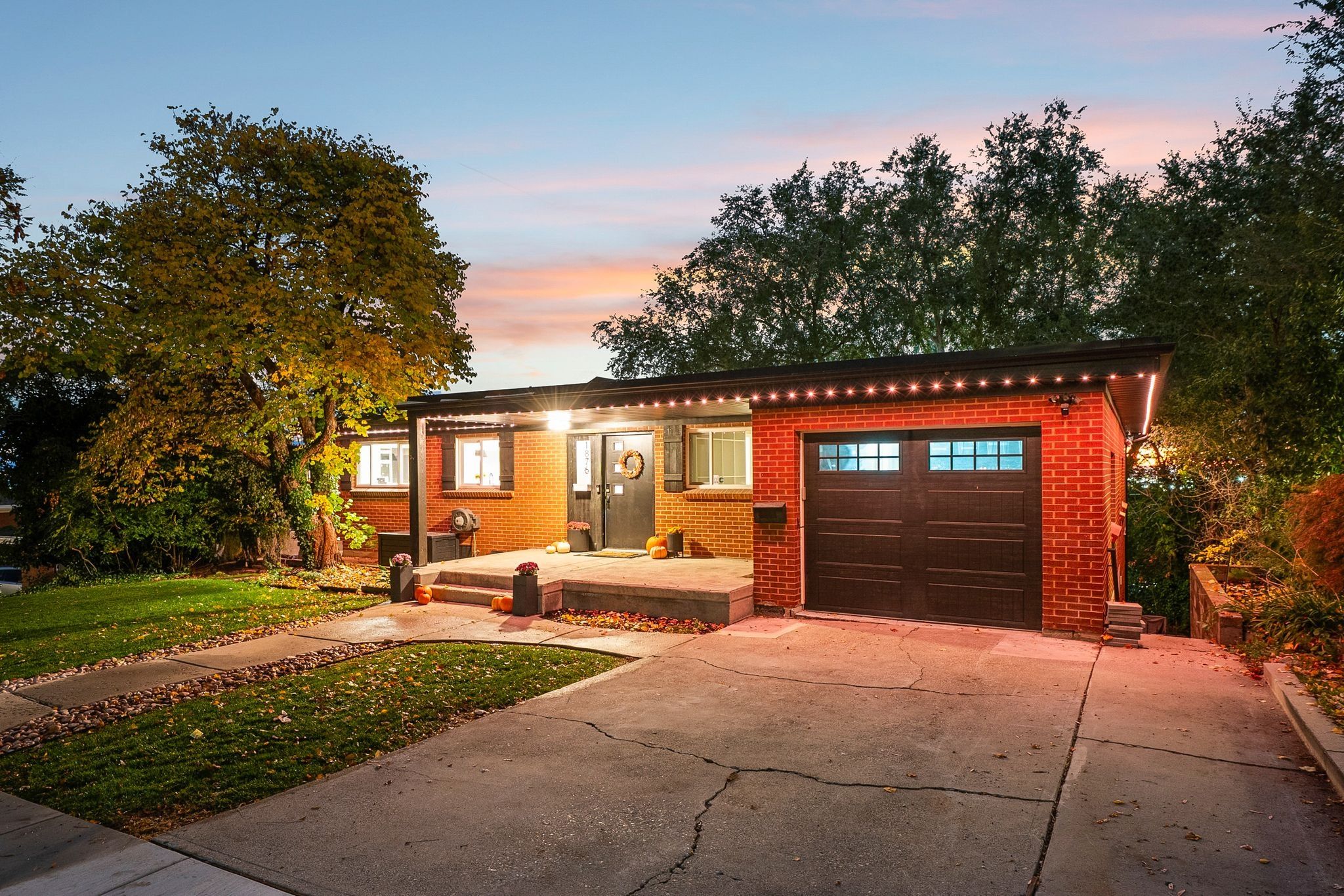 Brick exterior with a prominent single-car garage featuring a dark wood-finish door and upper window panels