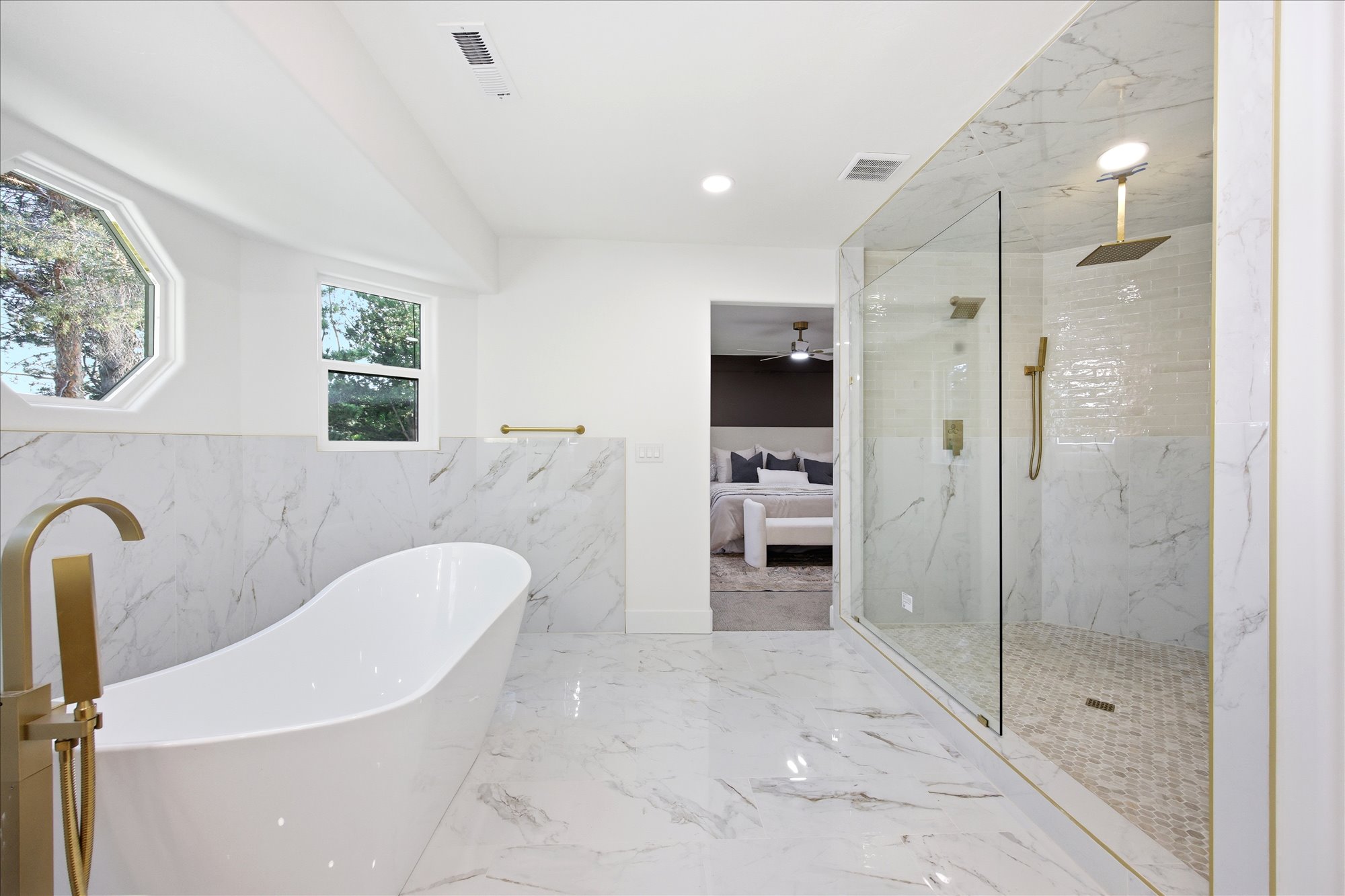 Freestanding soaking tub with gold-finish fixtures