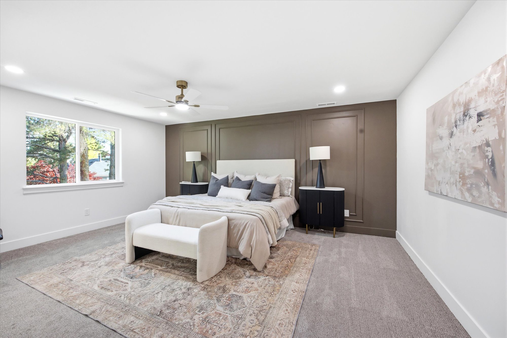 Spacious room featuring a large window, recessed lighting, and a ceiling fan