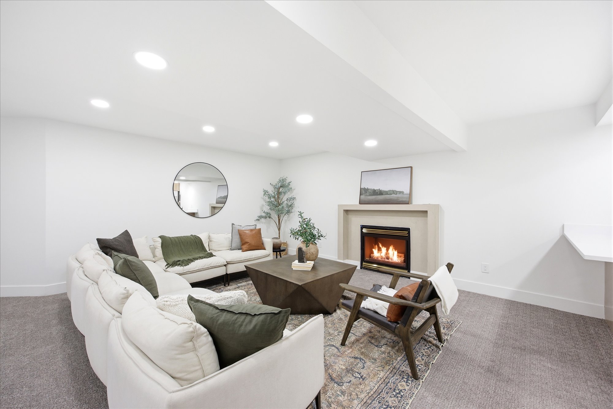 Living space featuring a built-in fireplace with a hearth, recessed lighting, and carpeted flooring