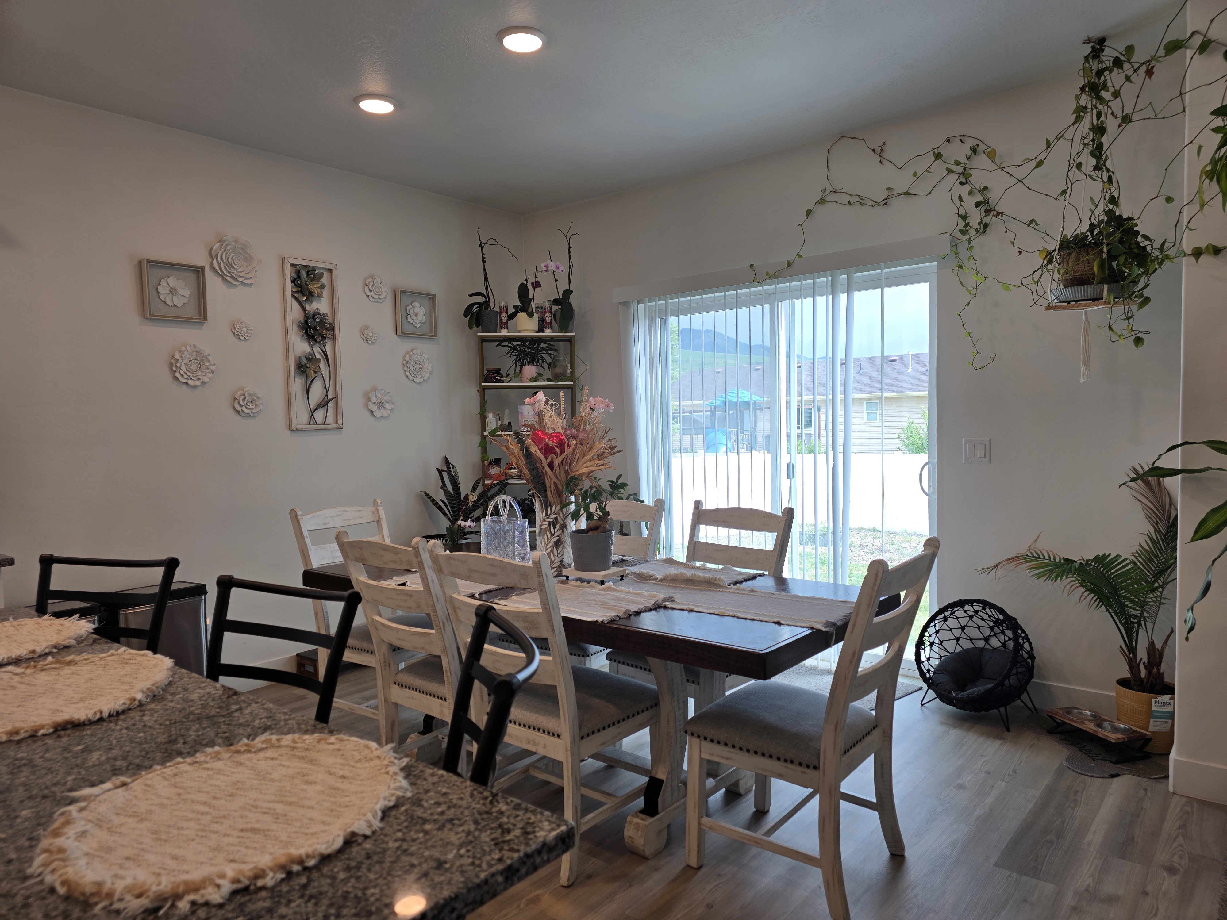 Dining area featuring wood-finish flooring, recessed lighting, and a sliding glass door