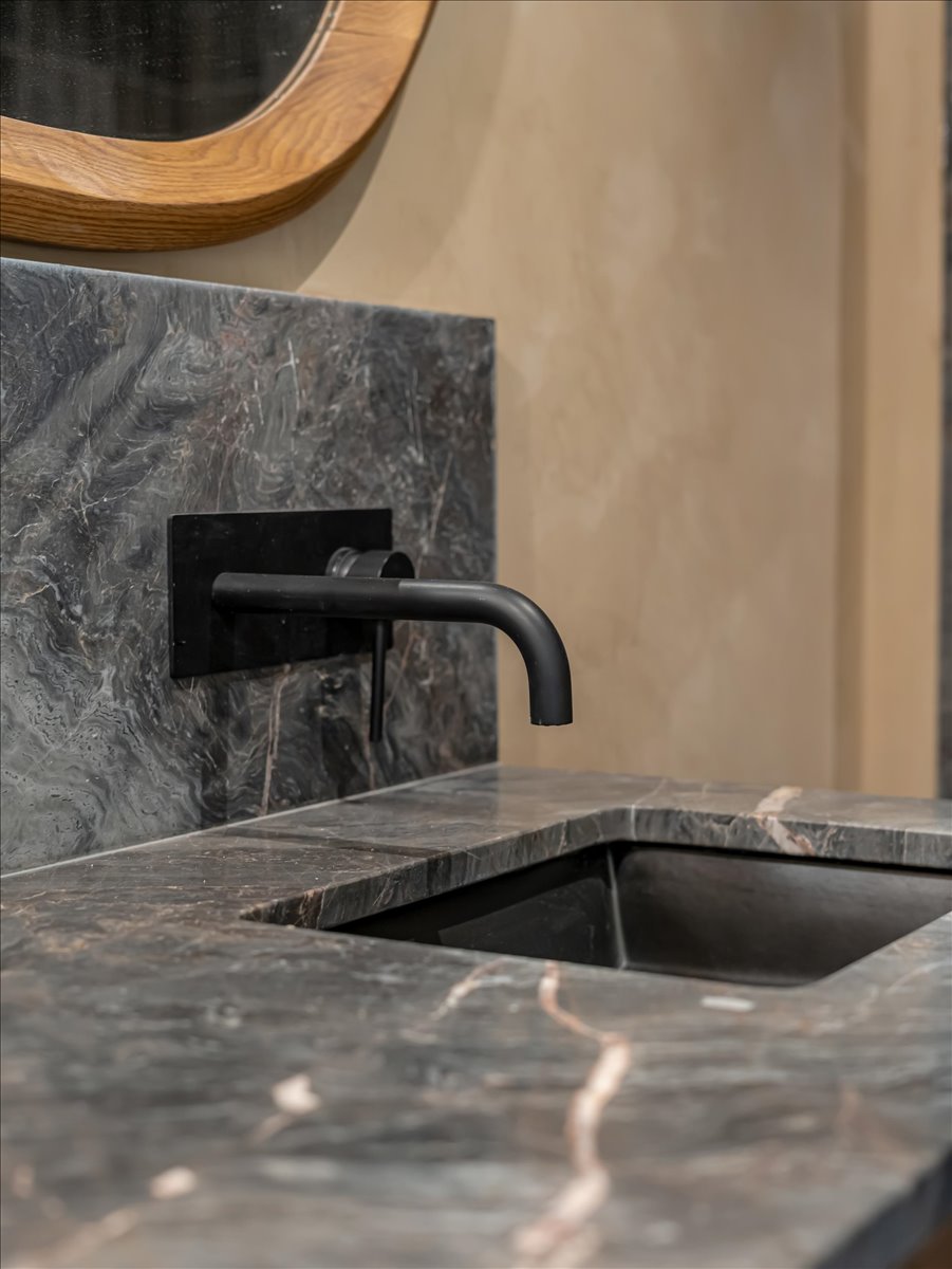 Natural stone countertop and backsplash with integrated sink