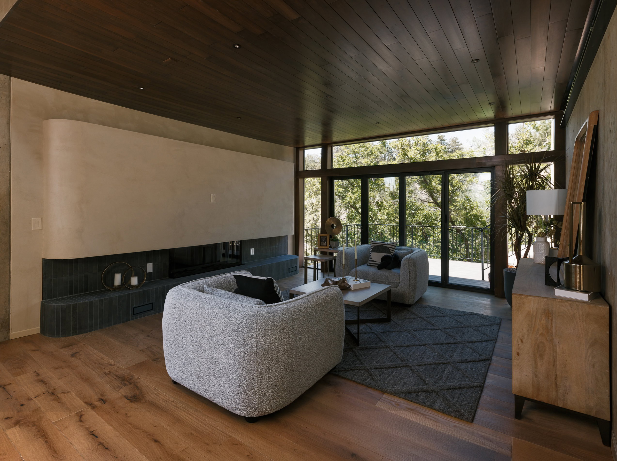 Living area featuring expansive floor-to-ceiling windows, flooring, and a dark wood plank ceiling