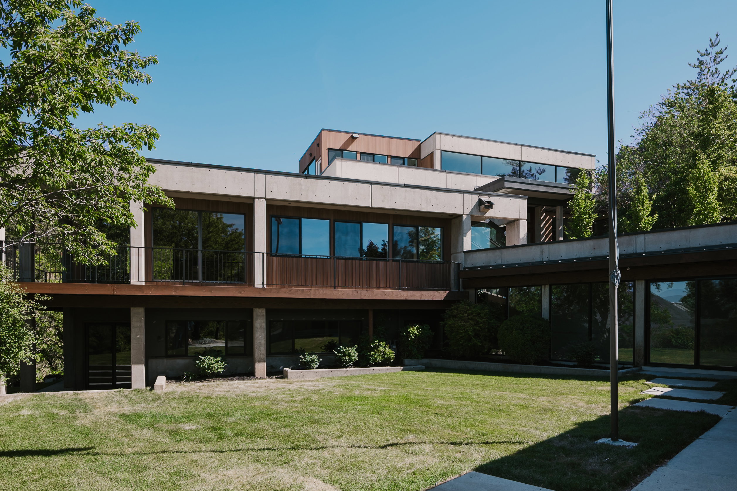 Contemporary multi-level exterior with concrete accents and extensive glazing