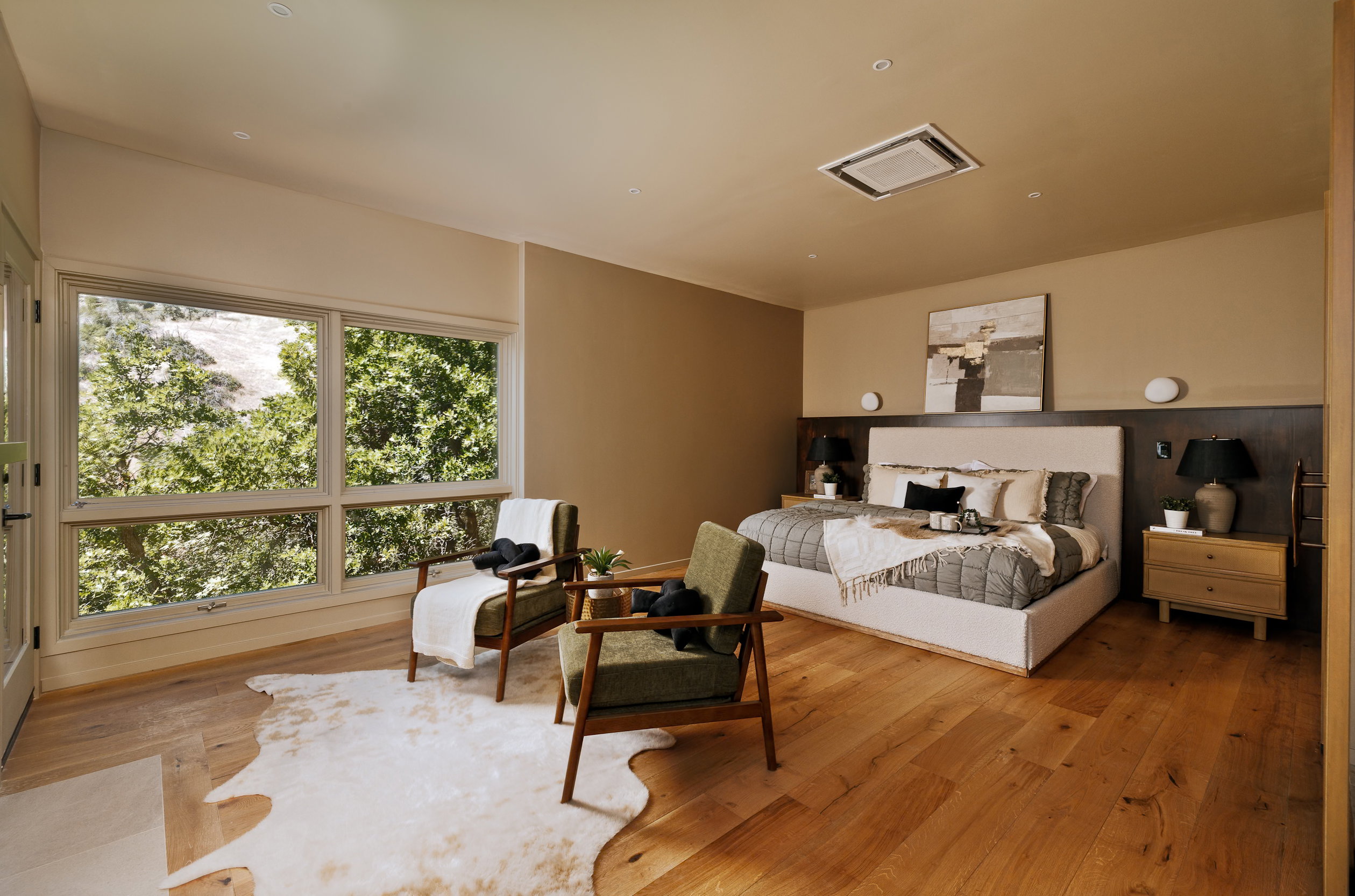 Spacious bedroom featuring wide-plank flooring, large picture windows, recessed lighting, and a built-in ceiling air conditioning unit