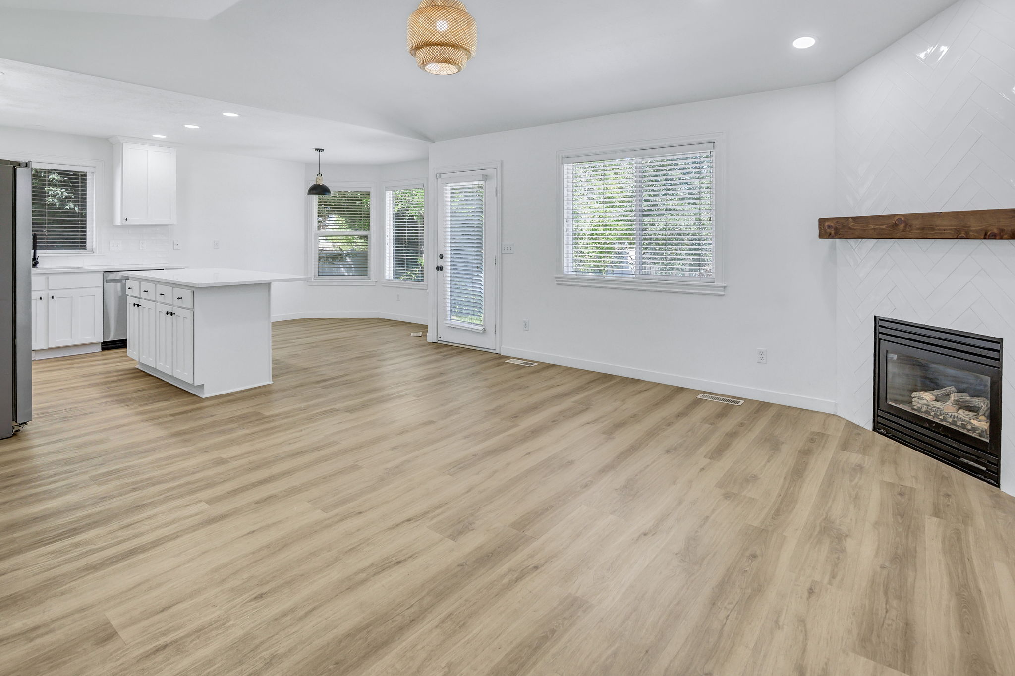 Expansive open-concept room featuring wood-finish flooring throughout