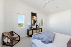 Primary bedroom with vaulted ceiling with a contemporary ceiling fan and recessed lighting