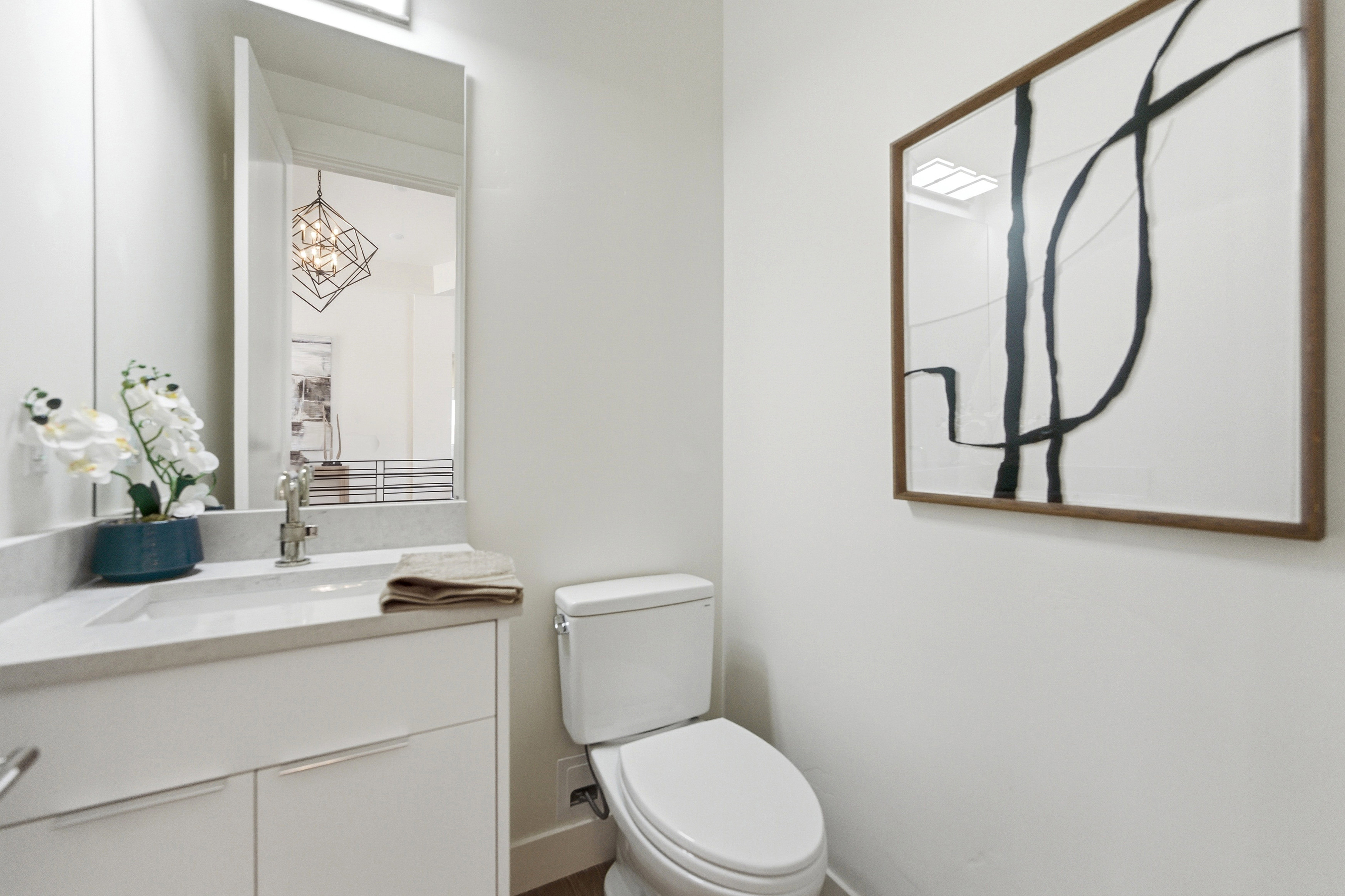 Hall bath, white vanity with an integrated rectangular sink, light-toned countertop, and chrome faucet