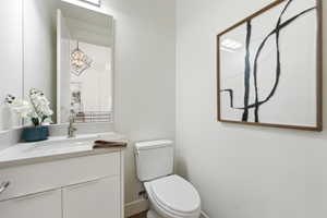 Hall bath, white vanity with an integrated rectangular sink, light-toned countertop, and chrome faucet