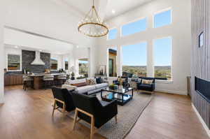 High ceilings with a prominent chandelier and expansive windows featuring distant mountain scenery