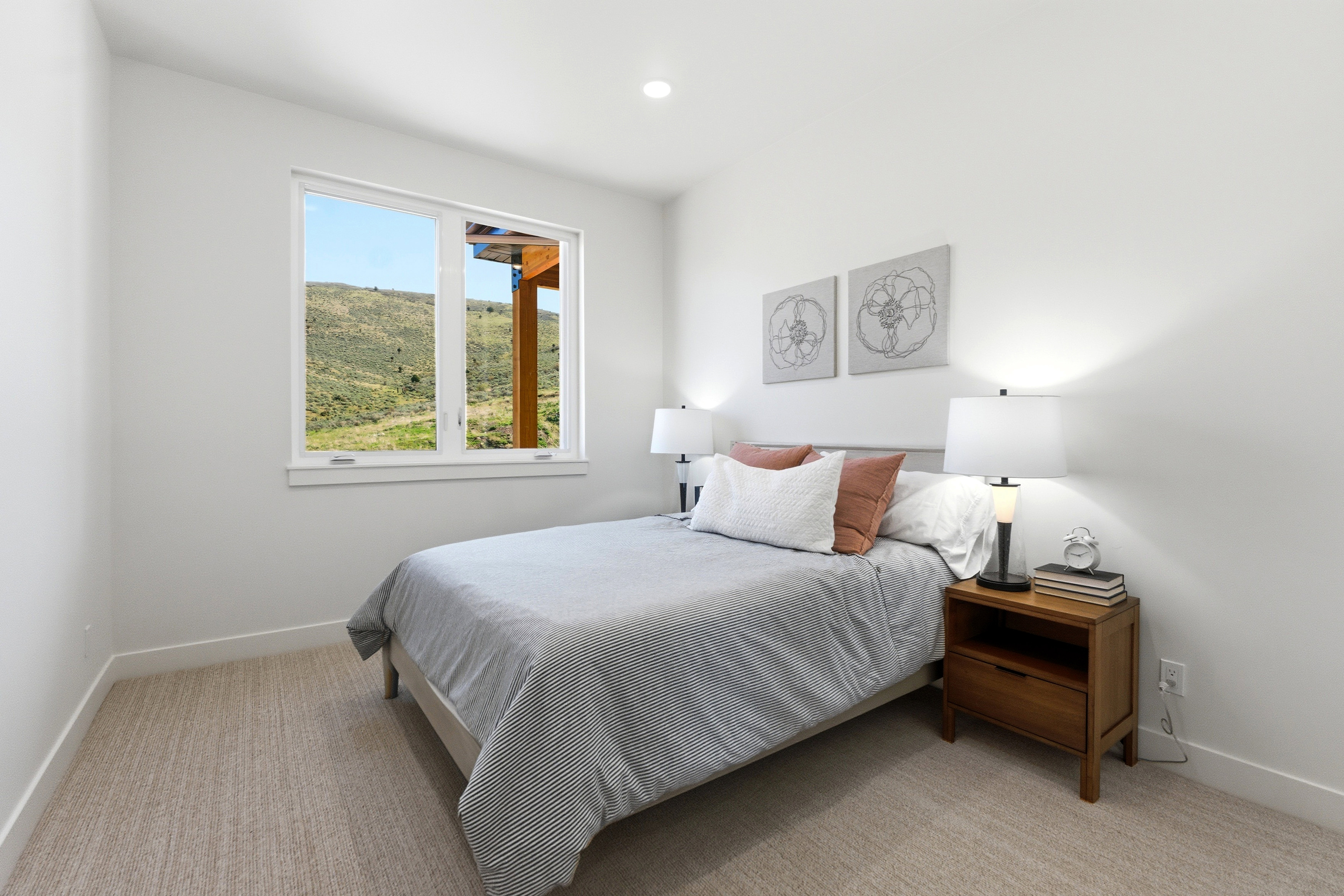 Bright room featuring a large window, recessed lighting, neutral wall paint, white trim, and light-toned carpet flooring