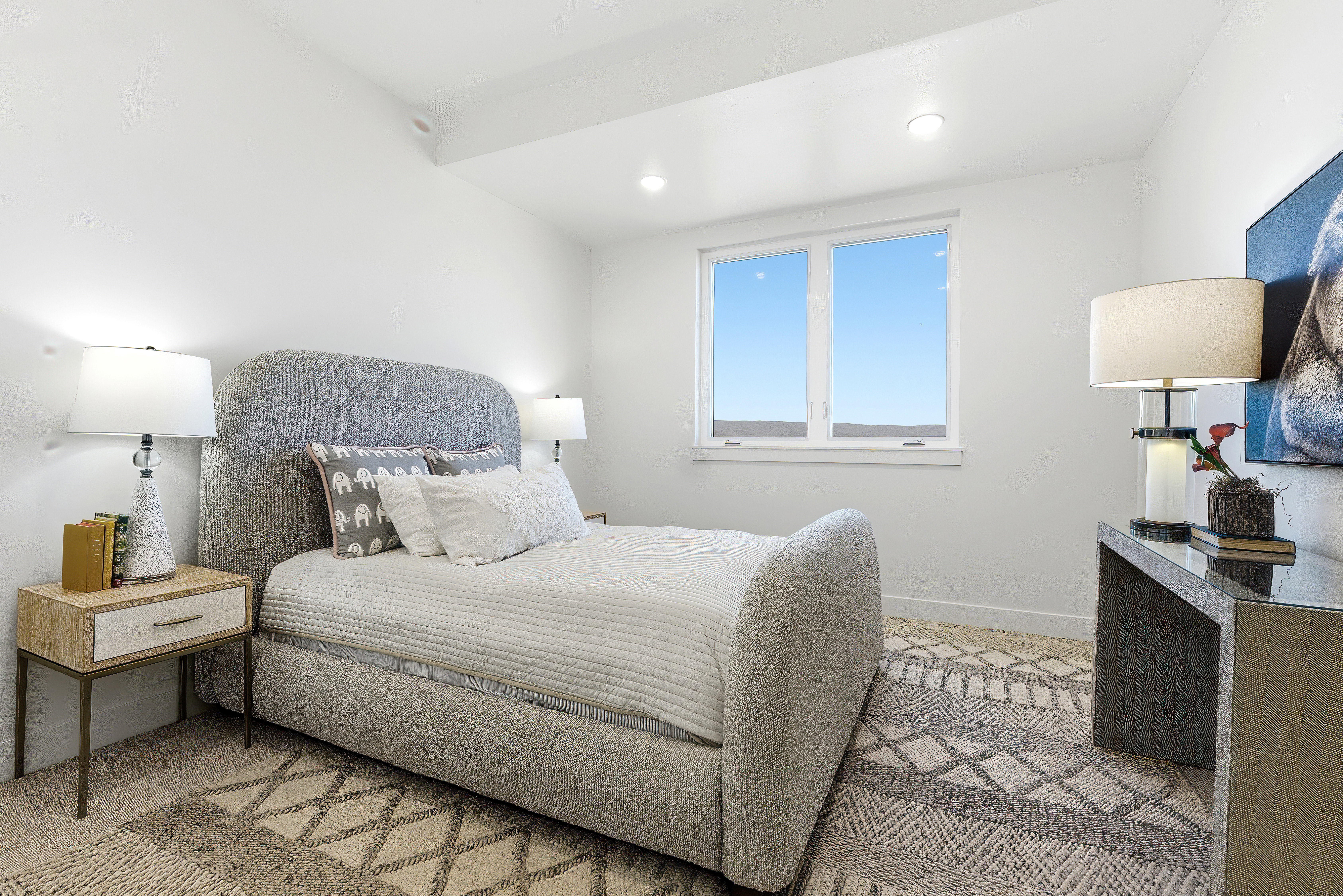 Bright sleeping area featuring recessed lighting, a modern window, and a textured area rug over carpeting