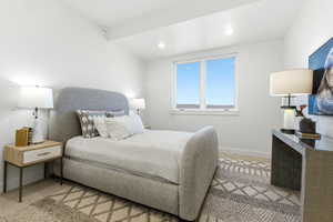 Bright sleeping area featuring recessed lighting, a modern window, and a textured area rug over carpeting