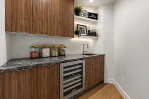 Wet bar in media room, digitally staged with wine fridge