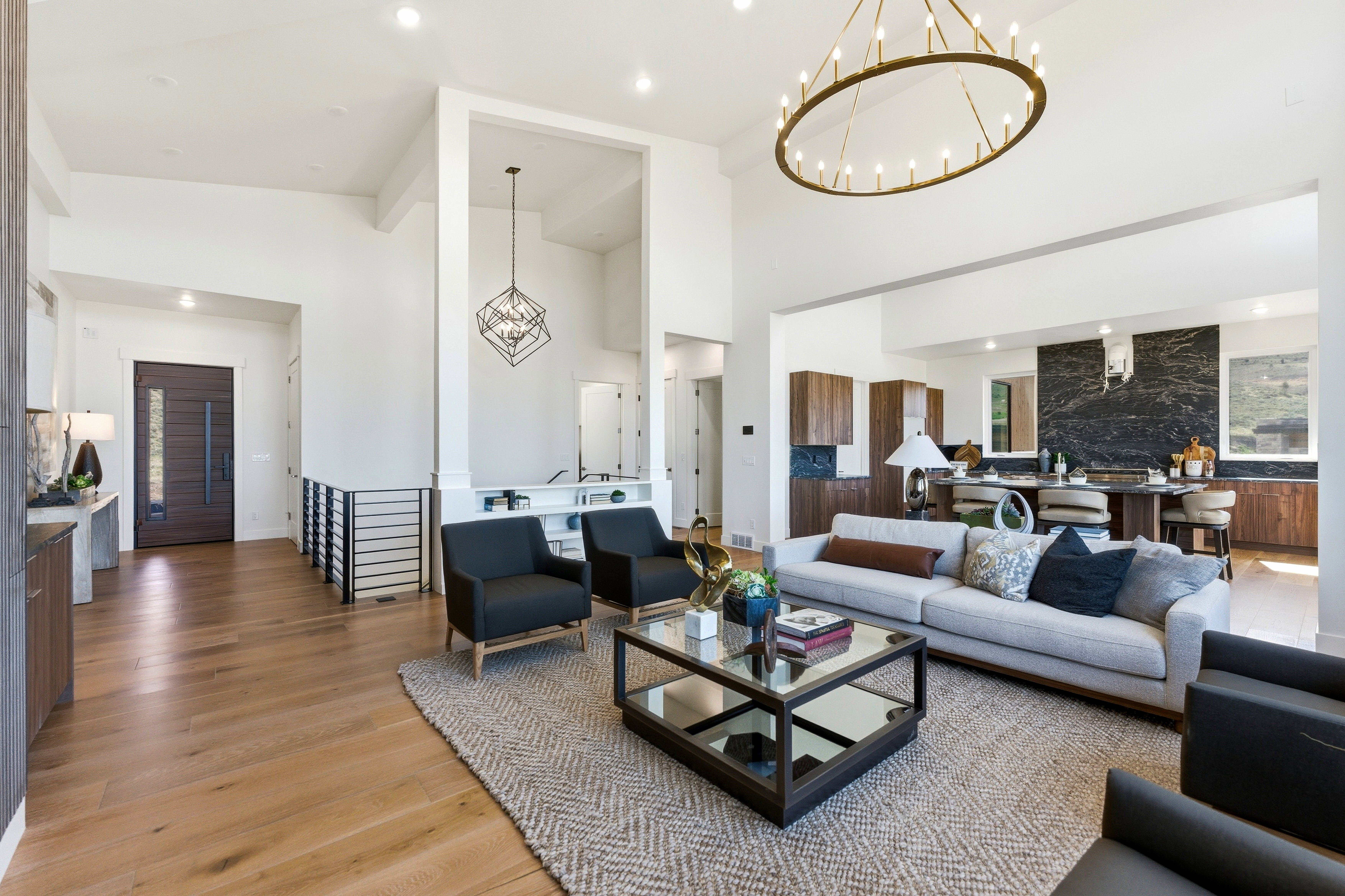 Living area featuring high ceilings, wood-finish flooring, and recessed lighting