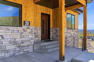Modern facade featuring natural wood siding and stone veneer