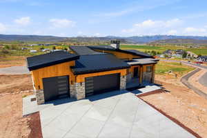 Modern single-level residence featuring a multi-tone wood-paneled exterior and stone accents