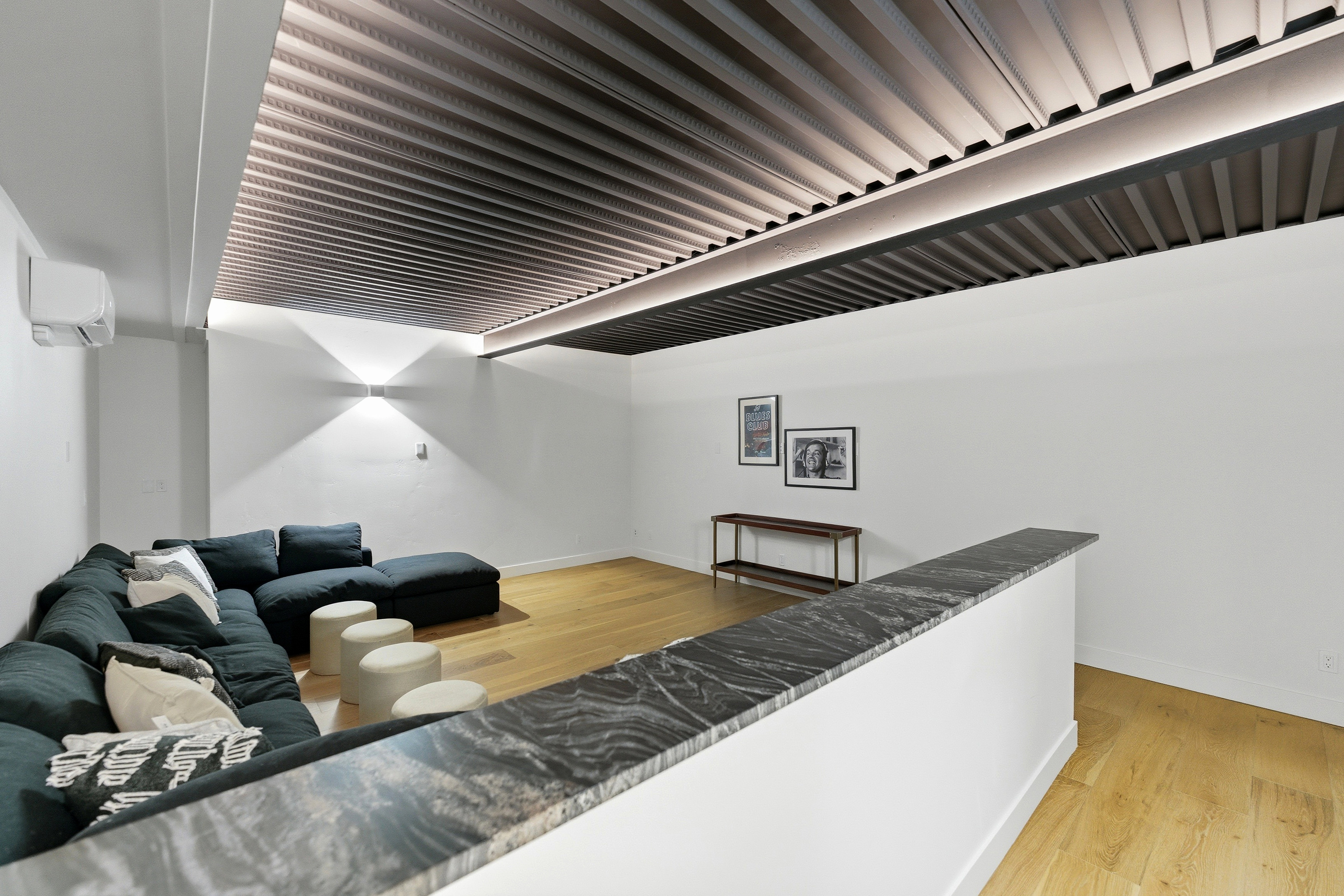 Recessed ceiling lighting illuminating a contemporary slatted ceiling design