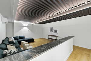 Recessed ceiling lighting illuminating a contemporary slatted ceiling design