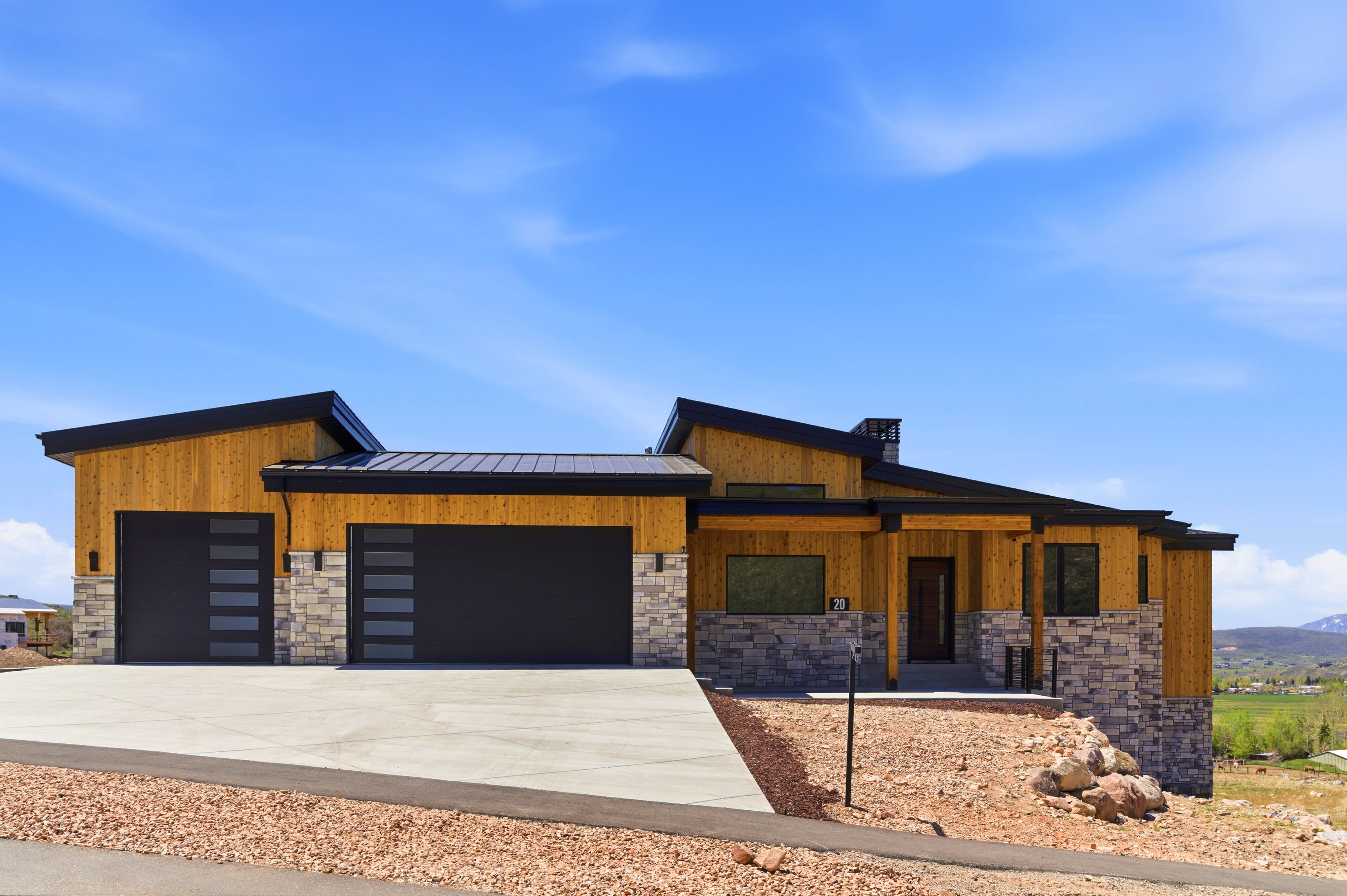Modern architecture featuring light wood siding and stone veneer accents