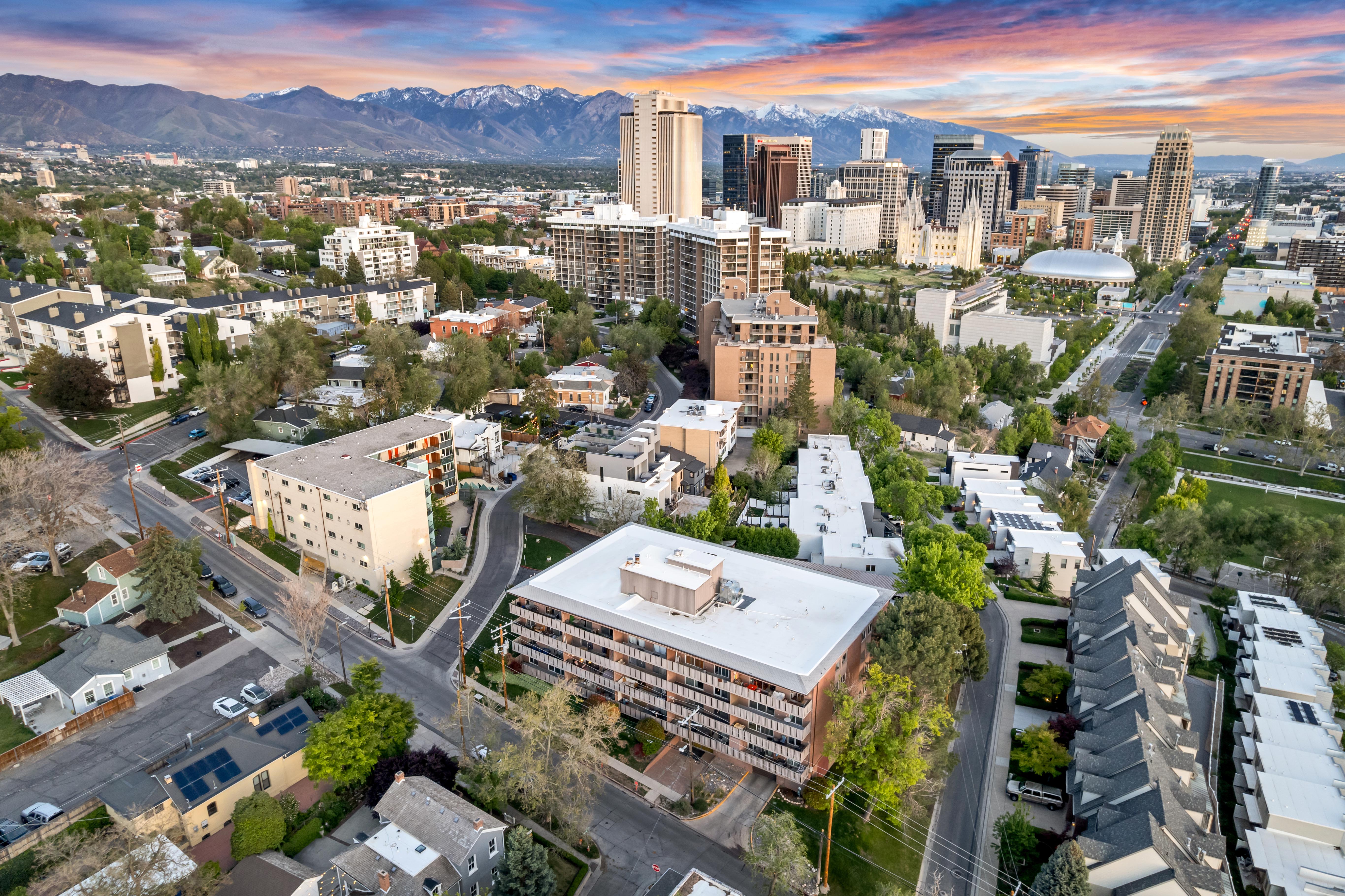 Cityscape featuring a dense urban environment with a variety of architectural styles, including modern high-rises and residential buildings