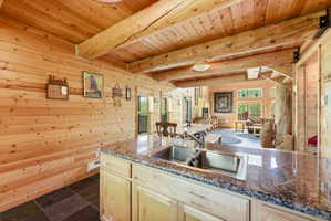 Kitchen island featuring a double basin stainless steel sink and a granite countertop