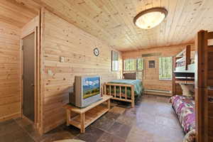 Wood-paneled room featuring natural wood walls and ceiling