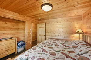 Interior room featuring extensive wood paneling on walls and ceiling