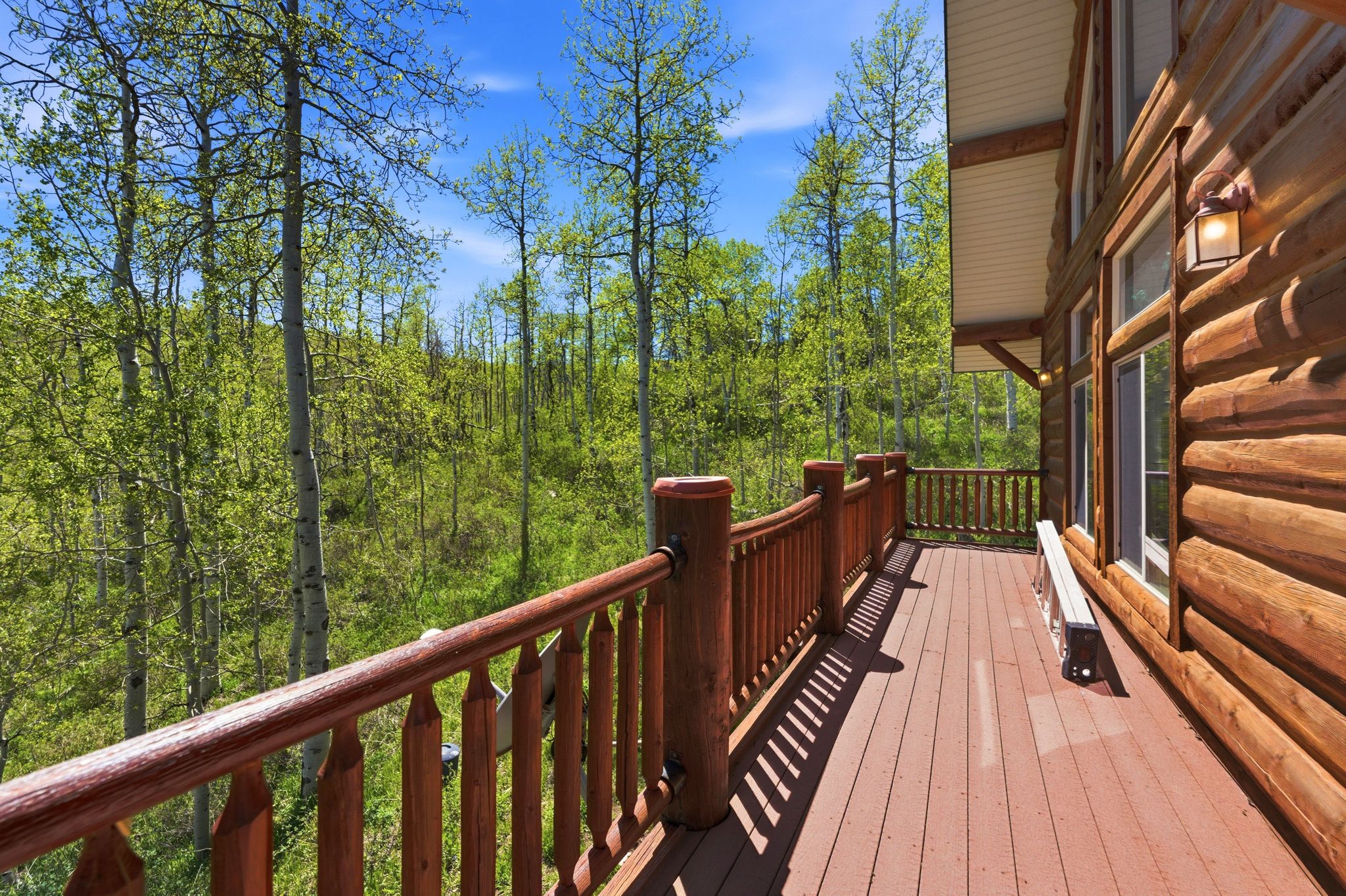 Expansive log-sided exterior with a natural wood deck