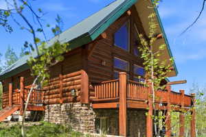 Log cabin style exterior with a metal roof and large A-frame windows