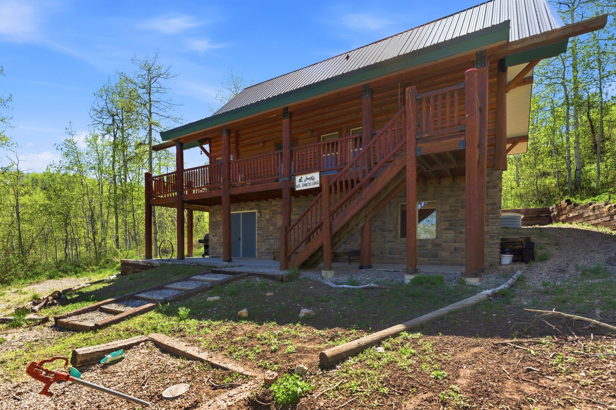 Two-story log cabin with stone foundation
