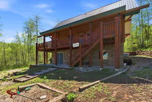 Two-story log cabin with stone foundation