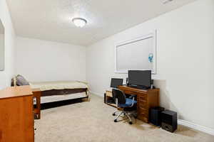 Carpeted room featuring white walls, a single window with blinds, and a built-in ceiling light fixture