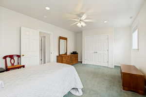 Bedroom featuring light green carpeting and white walls