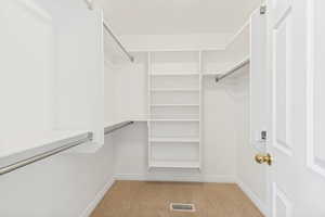 Custom-built closet system featuring white shelving and chrome hanging rods