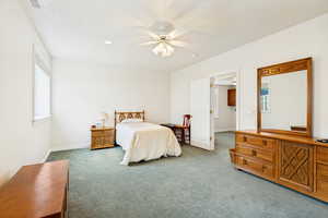 Spacious room featuring light-colored walls, recessed lighting, and a ceiling fan