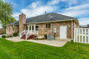 Brick exterior with a dark shingle roof, featuring a brick chimney and white trim