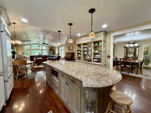 Kitchen island with stone-finish countertop and built-in microwave