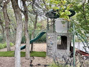 Outdoor play structure featuring a slide, climbing wall, and elevated platform