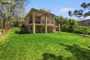 Spacious rear lawn with mature perimeter trees