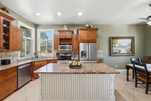 Kitchen featuring a central island with a granite countertop and beadboard paneling