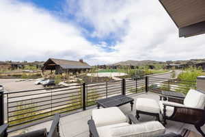 Expansive outdoor balcony featuring a concrete surface and a sleek black metal railing