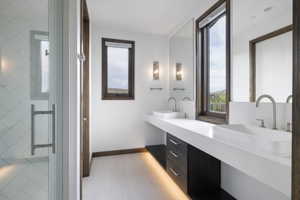 Modern bathroom featuring a dual vanity with rectangular vessel sinks and wall-mounted mirrors