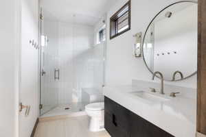Contemporary bathroom featuring a floating dark wood-finish vanity with an integrated white sink and counter