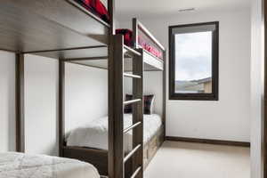 Built-in bunk beds with dark wood-finish frames and integrated storage drawers