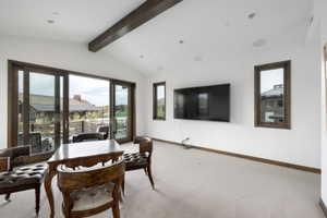 Sliding glass doors with dark wood frames open to an outdoor area