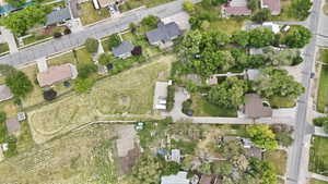 Expansive property featuring a cultivated field and established residential homes