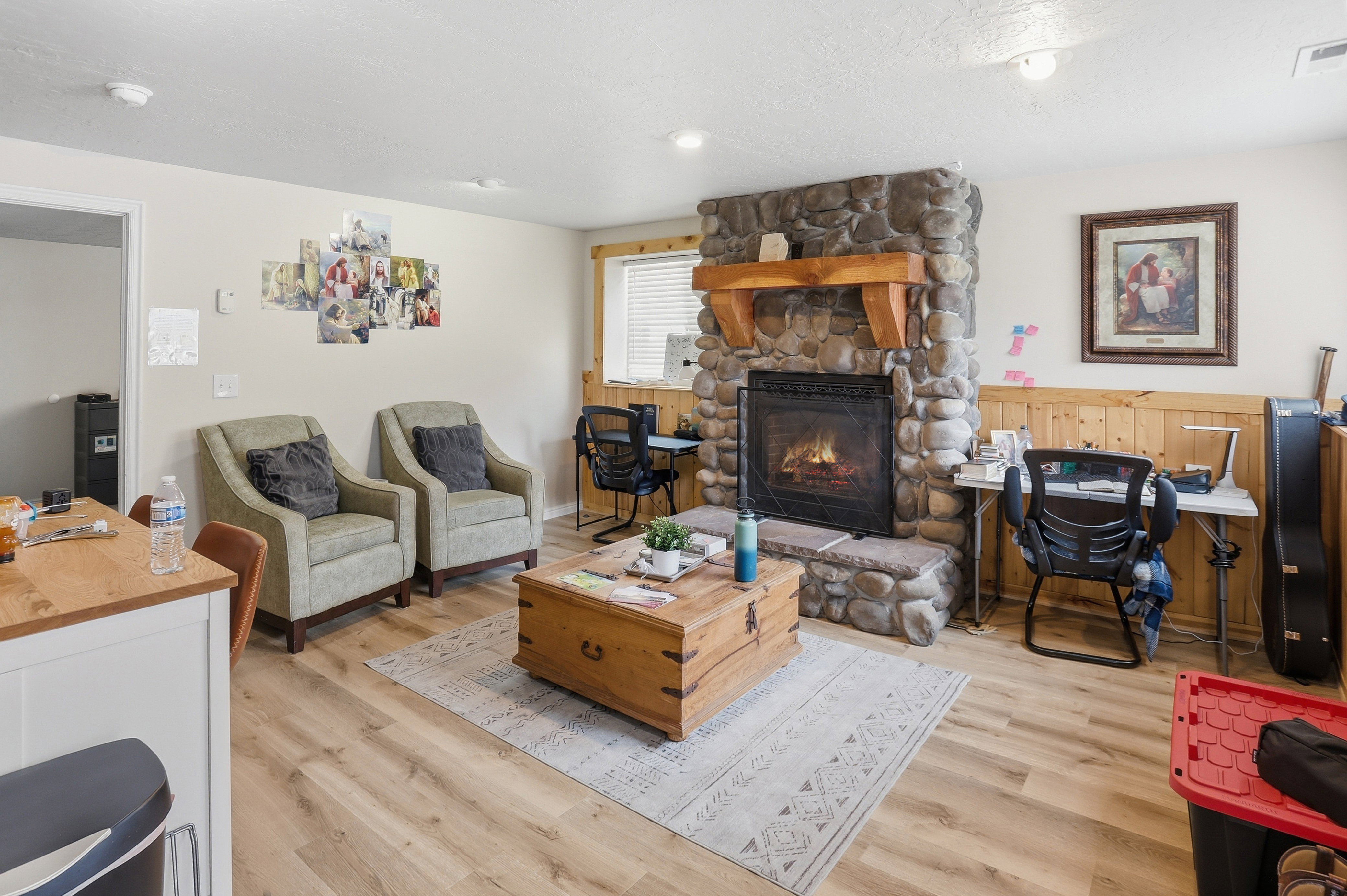 Stone-clad fireplace with a natural wood mantel