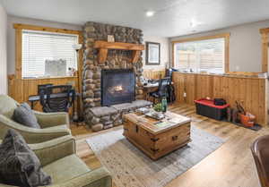 Stone-clad fireplace with a wood mantel