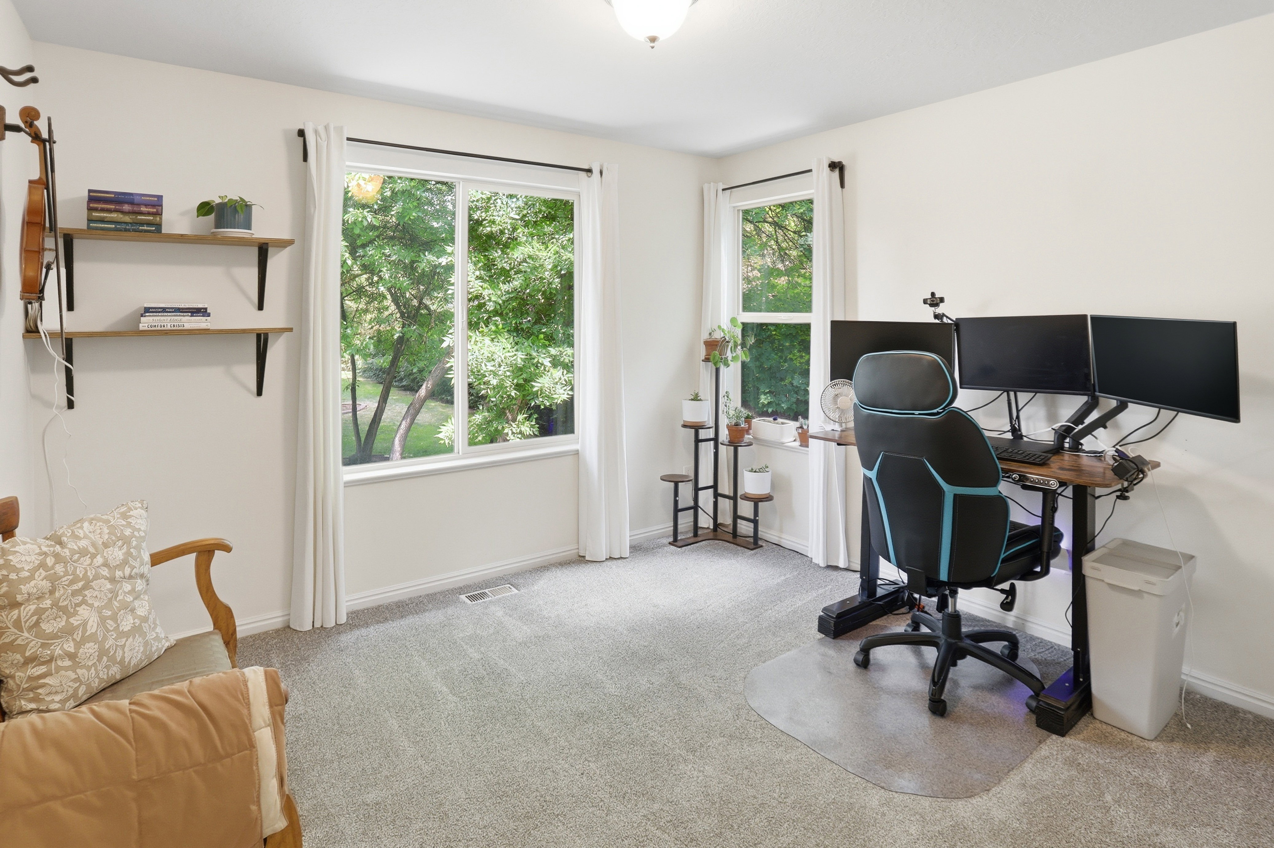 Room featuring light gray carpeting, neutral wall paint, and two windows with white trim